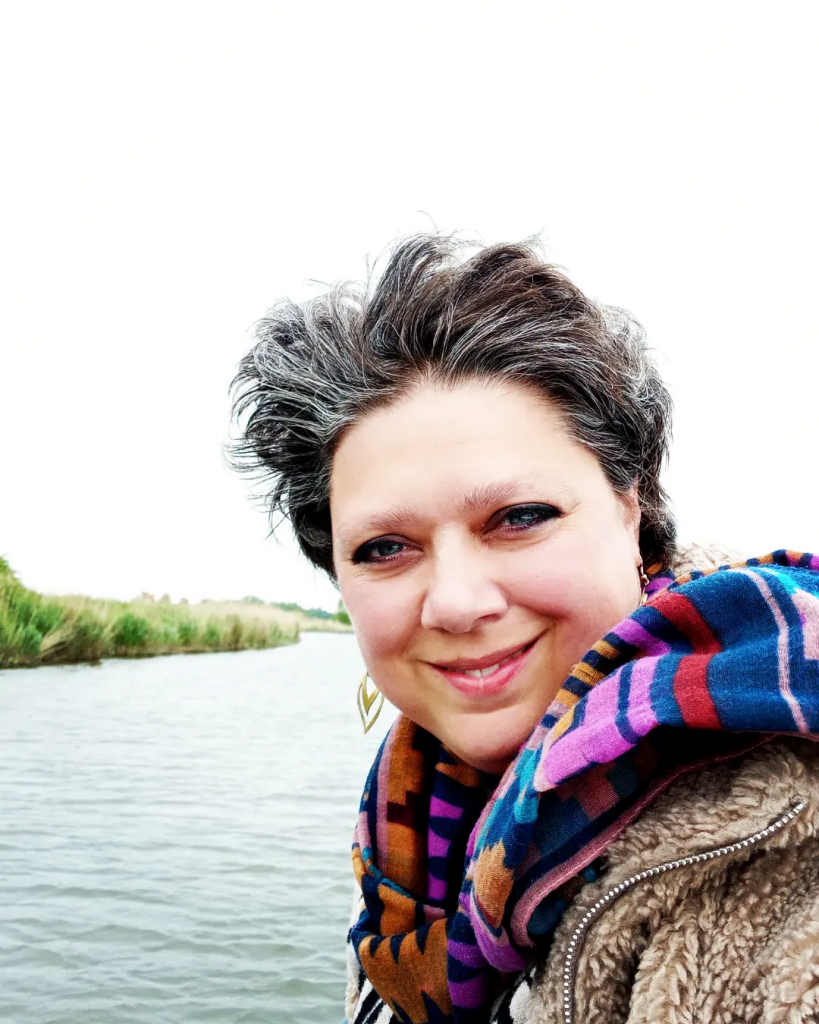 Photo of Emily Turner smiling in front of a lake